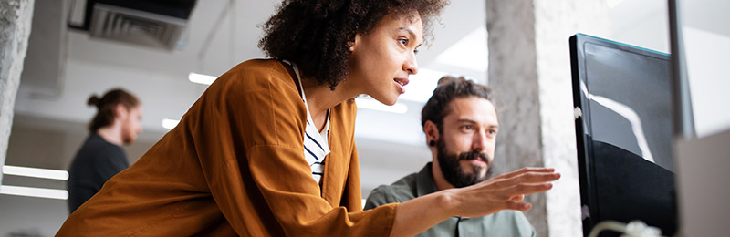Woman and man looking at computer