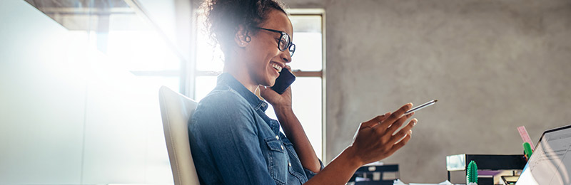 Woman smiling while on phone