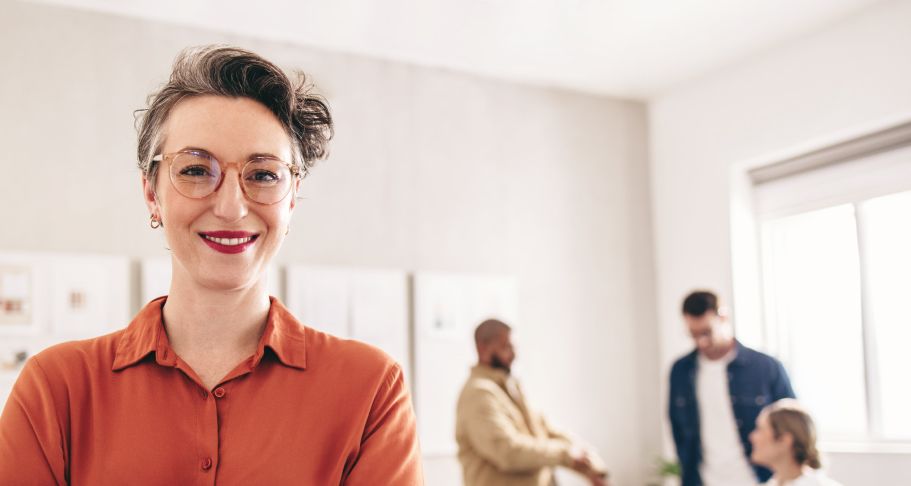 Woman smiling with meeting in background