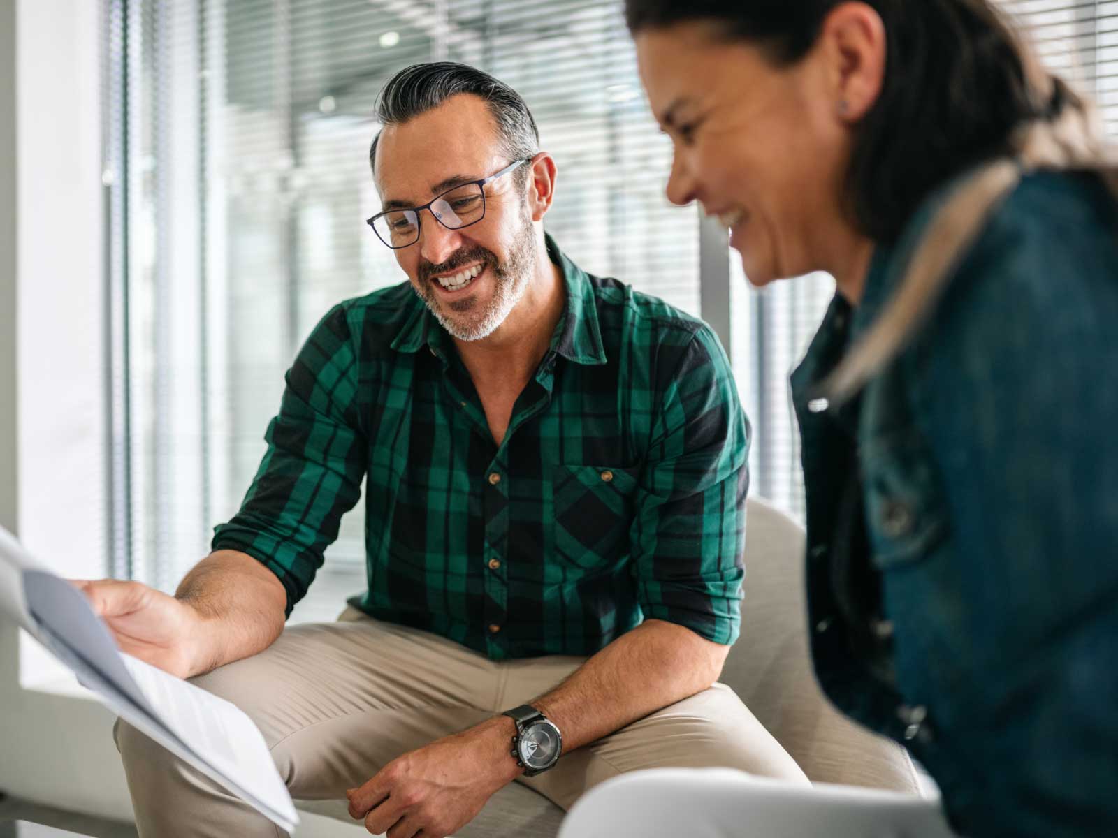 Man and Woman smiling at paper document