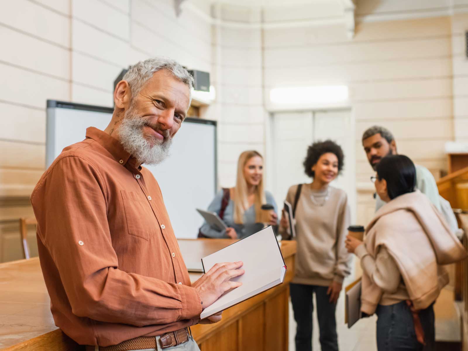 Older Man with book in classroom