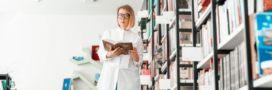 Female entrepreneur in her home office looking at ipad to review her notes that she has prepared for her business plan writer.